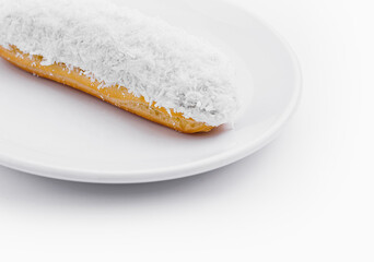 Wall Mural - eclair in white glaze and coconut flakes