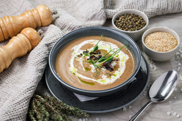 Wall Mural - Creamy mushroom cream soup with herbs and spices in a bowl