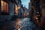 Fototapeta Uliczki - A charming cobblestone street illuminated by festive Christmas lights, perfect for holiday-themed designs