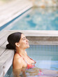 © Duncan M/peopleimages.com - Woman, happiness and relax in jacuzzi at spa with thinking, vacation or holiday fun in summer with bikini. Tourist, person and face with smile in pool for swimming, hydrotherapy and wellness at hotel