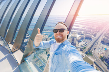 Poster - Selfie photo of happy young man tourist background skyscrapers in Dubai, UAE tourism travel