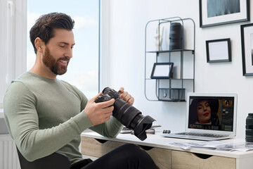 Poster - Professional photographer with digital camera at table in office