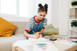© SHOTPRIME STUDIO - Artistic Teenage Girl Painting a Cute Portrait on Sofa: A Creative Home Hobby