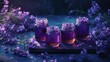 a group of jars filled with purple liquid sitting on top of a wooden cutting board next to a bunch of purple flowers.