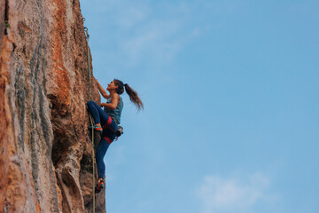 Wall Mural - silhouette of a girl climber. rock climber girl climbs an overhanging rock.