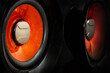 two audio speakers in close-up on a dark background