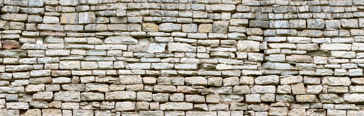Wall Mural - vintage stone wall made of gray boulders, old masonry background