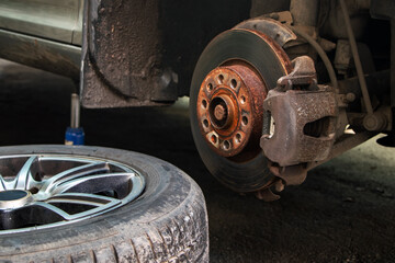 Wall Mural - Closeup disc brake of the vehicle for repair. shot wheel, the tool for loosening the nuts. internal screw