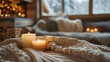 Candles and blankets. Warm and cozy natural decoration with blurred and bokeh background