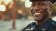 closeup of cheerful American cop standing on city street, smiling portrait of police officer on patrol duty