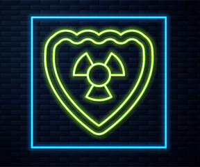Poster - Glowing neon line Radioactive in shield icon isolated on brick wall background. Radioactive toxic symbol. Radiation Hazard sign. Vector