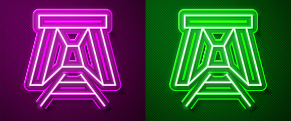 Glowing neon line Mine entrance icon isolated on purple and green background. Vector
