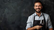 smiling sommelier with a glass of red wine on a black background with copy space