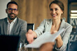 © bnenin - Businesswoman and businessman having a meeting with some clients, reading some documents.