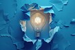 A conceptual image of a light bulb breaking through a blue box, symbolizing creativity and innovation.