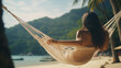 Woman relaxing on a hammock by the beach, enjoying the summer breeze and scenic beauty