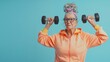 © Natalia S. - Active eldery grandmother doing sports with dumbbells, sporty lifestyle in retirement. Activity in old age, energy and movement on blue background