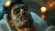 young, handsome man with a beauty mask on his face relaxes in the spa