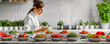 Elegant young cook in a modern, white kitchen, focusing on fresh, healthy ingredients.