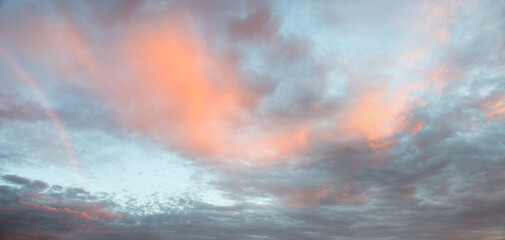 Wall Mural - sky background with fluffy clouds and light rainbow at the left side