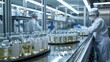 Pharmaceutical Production Line with Technicians Technicians in sterile environment oversee the pharmaceutical production line, ensuring quality control in medication manufacturing.