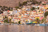 Fototapeta Boho - Multi-colored facades of houses in the Greek village Symi on a sunny day
