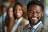 Fototapeta  - A cheerful, bearded African businessman surrounded by smiling colleagues