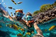 A man and a woman are snorkeling in the ocean, exploring the underwater world. The crystal clear waters allow them to observe a variety of marine life as they swim effortlessly