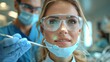 Woman in electric blue goggles getting dental exam in dentists office