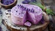 Artisan lavender cheese on a wooden board, surrounded by sprigs of lavender. Ideal for culinary articles and dairy products promotion.