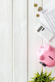 Fototapeta Mapy - Piggy bank with money and budget taxes calculations and bills. Economy concept