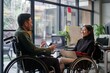 Two Asian colleagues in wheelchairs share a light moment, laughing and discussing work in an inclusive, DEI-focused workplace setting.

