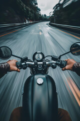 Closeup of two hands on motorcycle handlebars, motorcyclist on paved road.