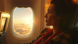 Woman traveler sitting near window on airplane during flight