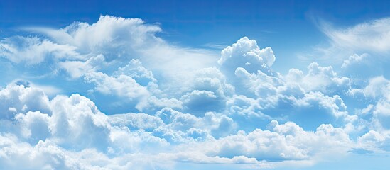 Poster - A plane is seen flying through a cloudy blue sky, leaving a trail in its wake. The clouds create a dramatic backdrop against the deep blue hues of the sky.