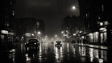 Film Noir Style Monochrome Image Of A Rainy City Street At Night With Cars On The And People Walking Past Lamp Lit Shops And Buildings Reflected On The Wet Ground