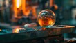 Glass orb reflecting a fiery forge, craftsmanship in glassmaking