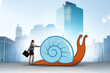 Businessman with snail in slow business concept