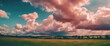 Panoramic landscape of lush green fields under a dramatic sky, hinting at the dynamic weather of the serene setting.