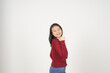 © Sino Images Studio - Young Asian woman in Red t-shirt Pointing side at copy space with thumb isolated on white background