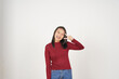 © Sino Images Studio - Young Asian woman in Red t-shirt smiling and showing peace or victory sign showing  isolated on white background