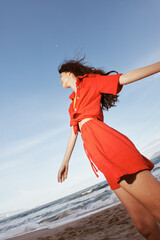 Canvas Print - Smiling Woman Dancing in the Summer Sea Breeze, Embracing Freedom and Joy under the Sunny Blue Sky