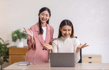 Two young asian happy business women working together for analyze planning and financial statistics and investment market  in home office space