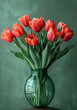 Tulips in green glass vase on green Background Spring tulip bouquet
