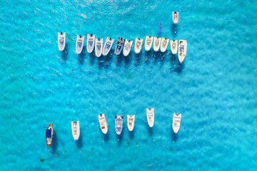 Wall Mural - Vacation and leisure. Aerial view on fast boats on blue Mediterranean sea at sunny day. Fast ships on the sea surface. Seascape from the drone. Seascape from air. Seascape with motorboat.
