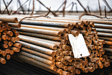 Round fittings in packs are stored in the warehouse of the steel products plant. Round metal rods for the modern production of metal products.