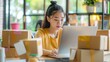 © buraratn - Startup small business entrepreneur SME freelance asian woman working with box, Asian woman small business owner, online e-commerce marketing box delivery, SME telemarket overtime stress concept