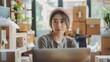 © buraratn - Young woman small business owner working at home office. Online marketing packaging delivery, startup SME entrepreneur or freelance woman concept. Small business owener
