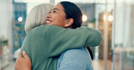 Senior woman, hug and old friend at a business office with a smile, support and excited. Elderly person, love and happy women together at a workplace with care from staff at physiotherapy with health