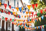 Fototapeta Boho - Triangular holiday flags on a string on street home party, blurred background. Colorful Holiday party decorations for backyard party